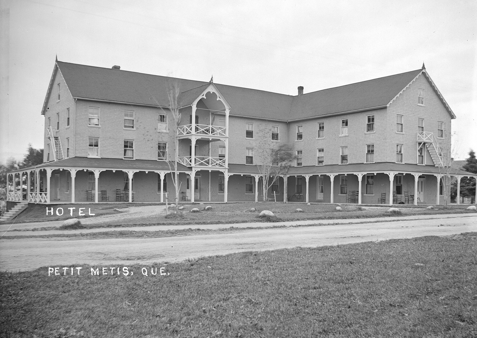 Photograph of a large hotel bordered by a well maintained lawn.