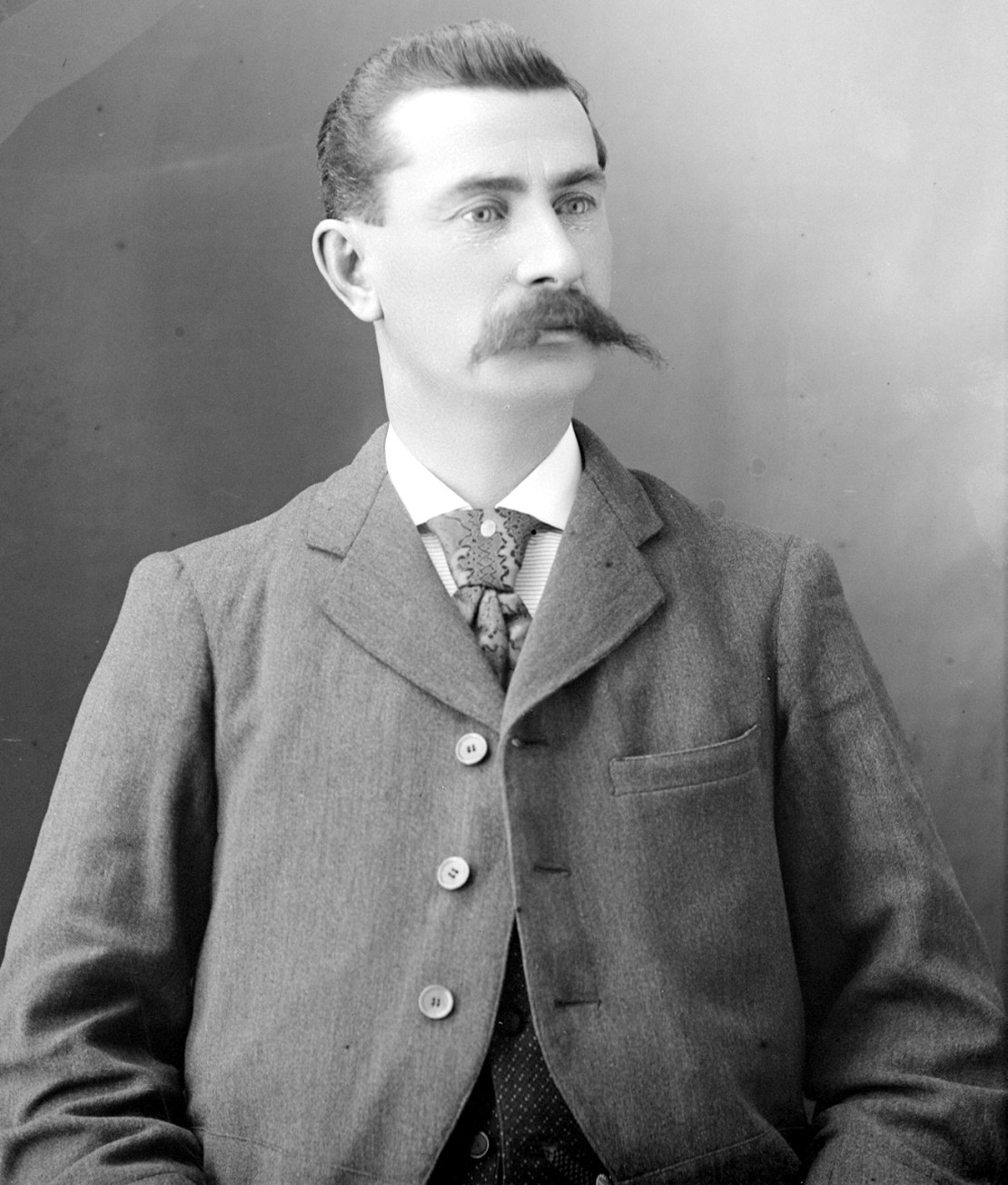 Portrait of a distinguished man sporting a prominent mustache.