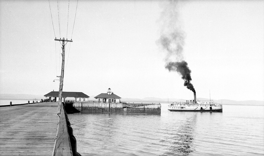 A steamboat at the end of a wharf.