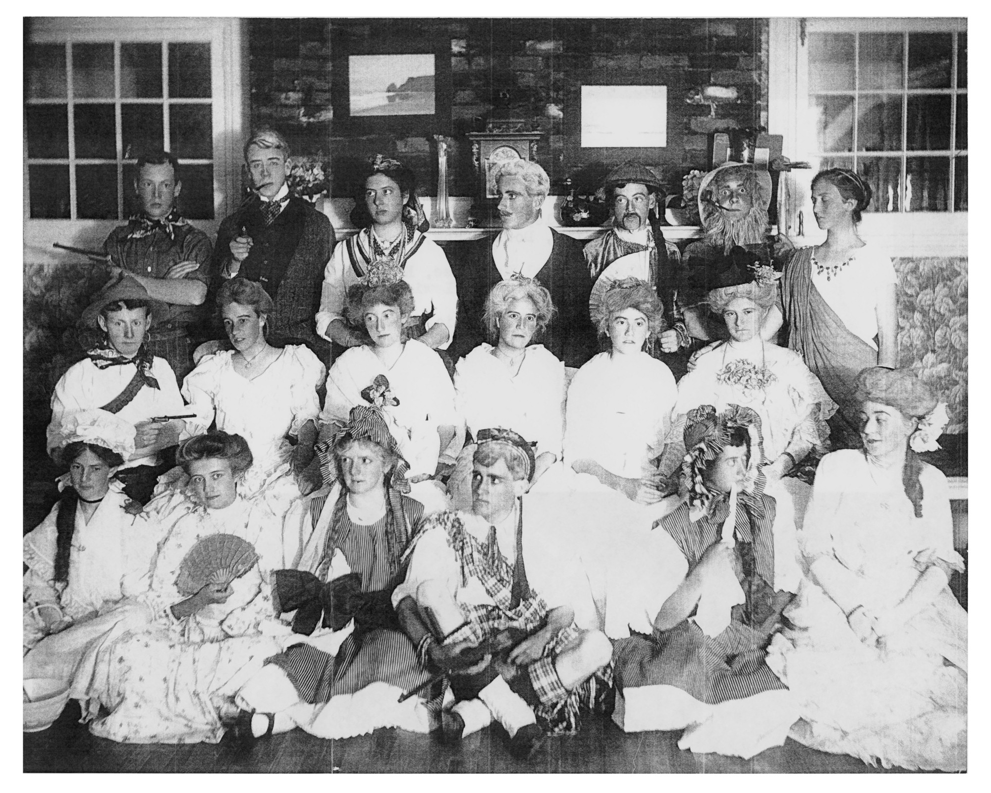 Two dozen adolescents in party costumes strike a pose inside a villa.