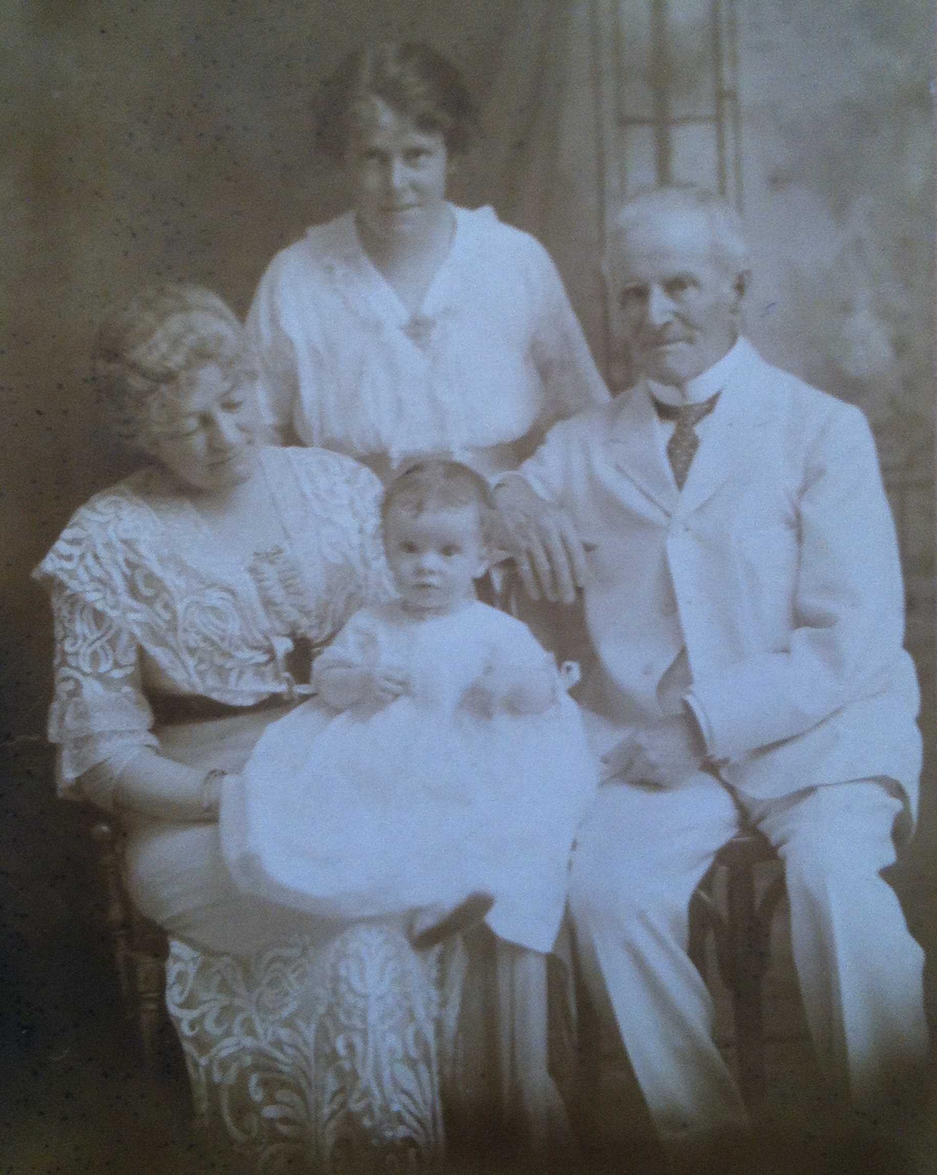 Black and white portrait of the family, sitting.