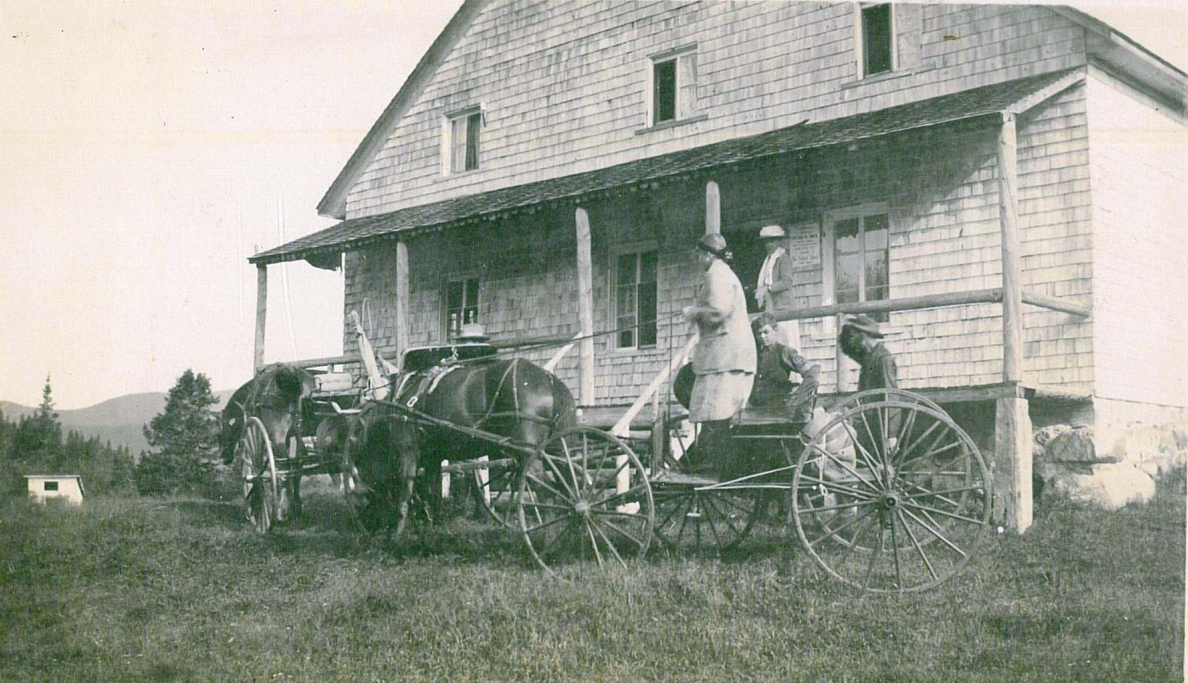 Photograph of a large family on steps leading to a veranda.