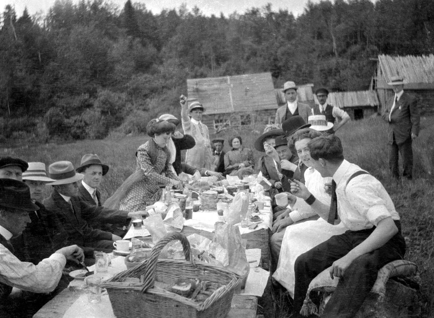 Photograph of some twenty young people at a picnic.