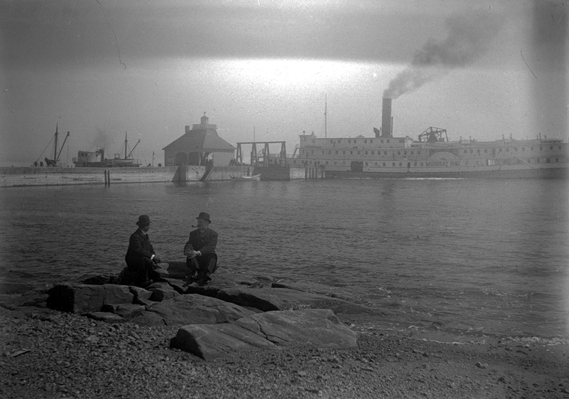 A cruise steamer at the end of a wharf.