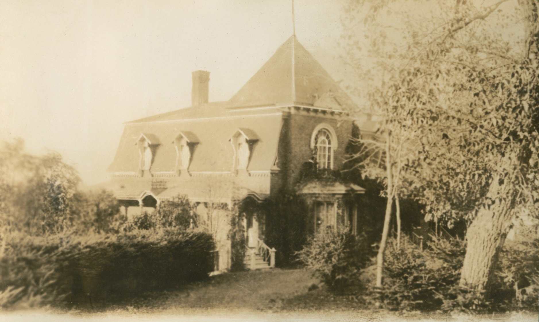 An elaborately decorated old residence surrounded by greenery.