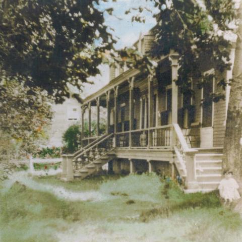 Painted photograph of a residence with a large gallery, surrounded by vegetation.