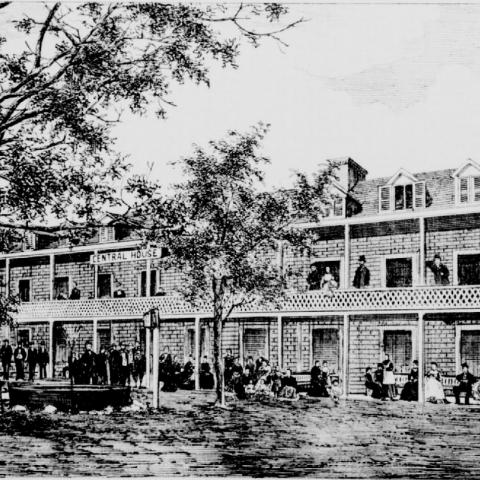 Black and white engraving representing a modest-looking hotel.