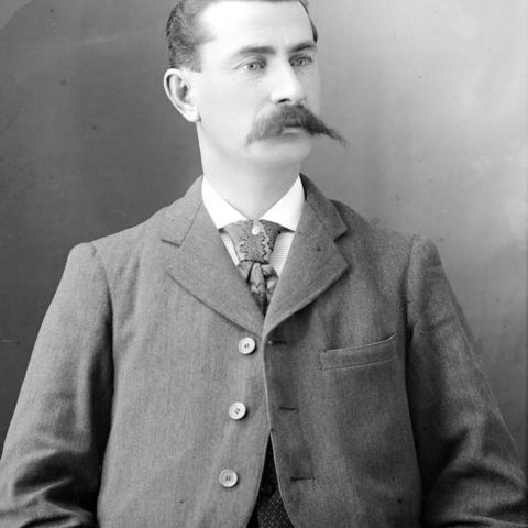 Portrait of a distinguished man sporting a prominent mustache.