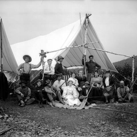 A family posing in front of a hunting tent