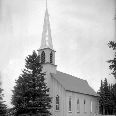 A small church in a wooded area.