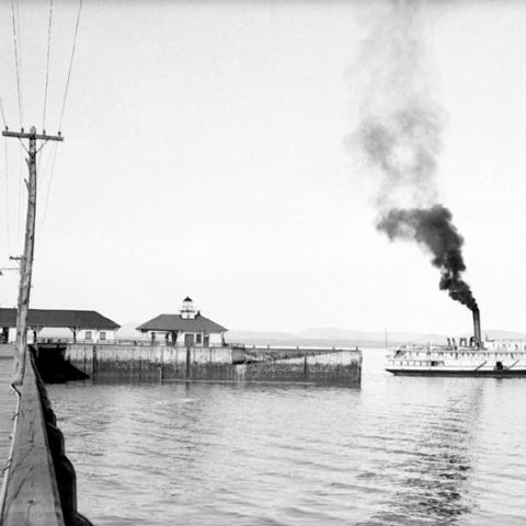 A steamboat at the end of a wharf.