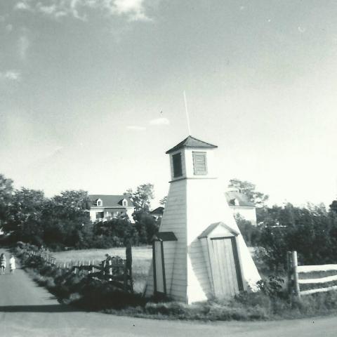 A photograph shows a changing-cabin on the lower part of a slope where two roads meet.