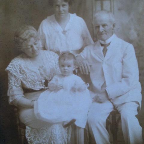 Black and white portrait of the family, sitting.