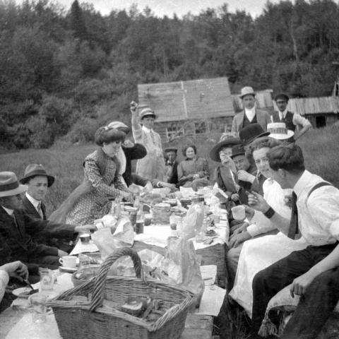 Photograph of some twenty young people at a picnic.
