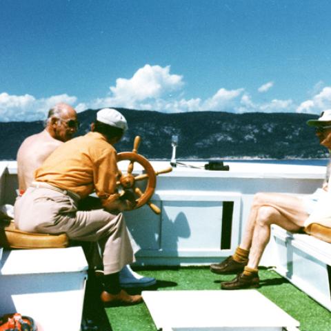 Three men on a small boat.