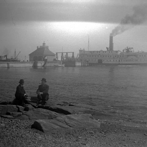 A cruise steamer at the end of a wharf.