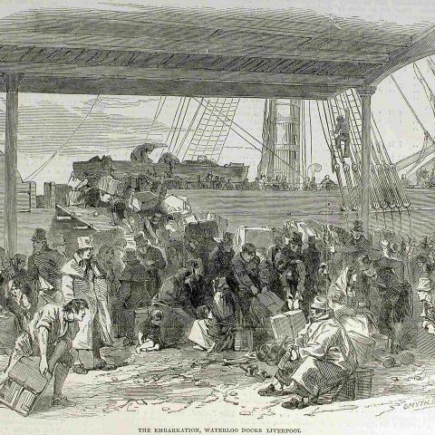 Engraving of a dock where a crowd is boarding a sailing vessel with an impressive amount of baggage.