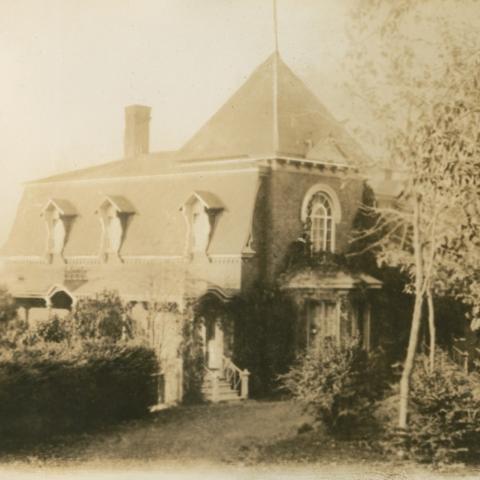 An elaborately decorated old residence surrounded by greenery.