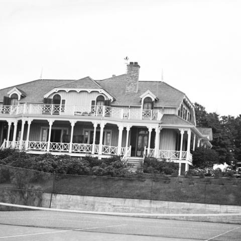 A villa with a tennis court.